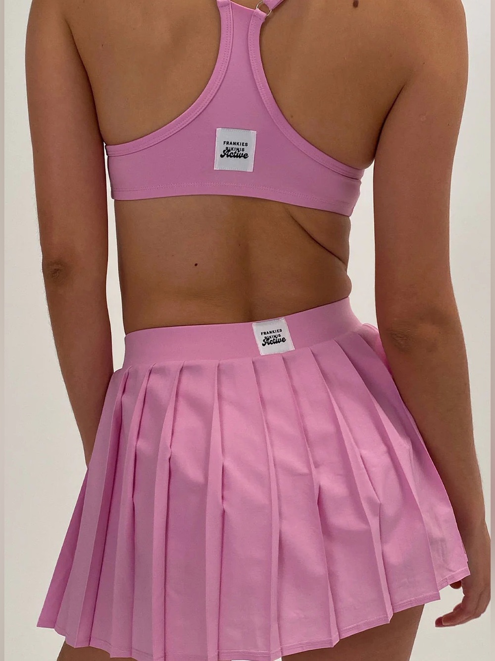 Frankie’s bikinis Hot Pink Lively Halter Sports Bra & Mini Skirt Set